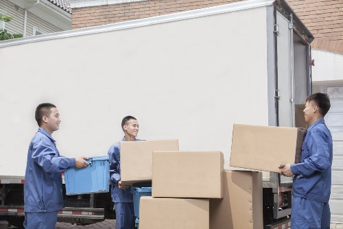 Furniture pick-up team handling a sofa collection in Greenwich