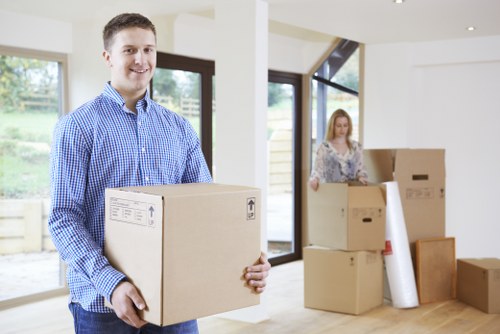 Packed boxes and furniture ready for loading into a van