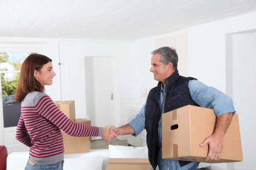 Professional movers handling furniture in a Greenwich residential street